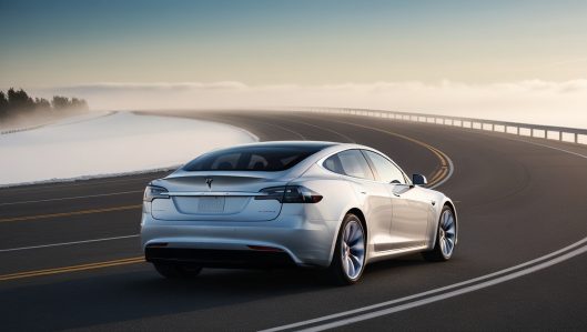 Leonardo_Phoenix_A_sleek_snowy_white_Tesla_car_is_positioned_o_0